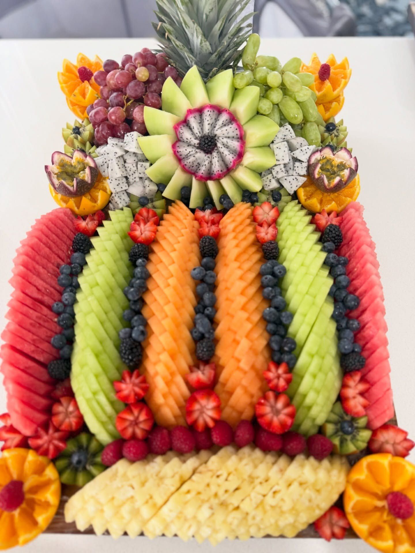 A 60cm classic fruit board with rows of melon, berries and a dragon fruit flower