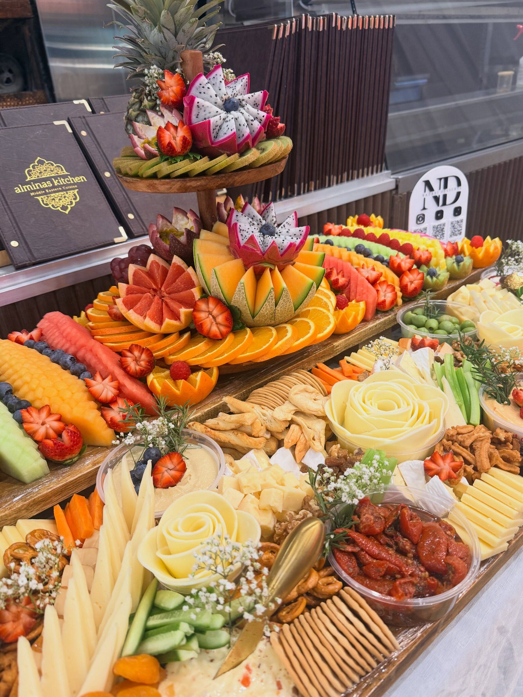 A Signature Grazing Package with a carved fruit tier and cheese roses at a Nikah